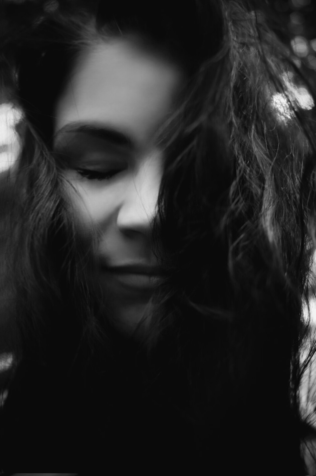 Portrait of a woman with wavy hair smiling softly